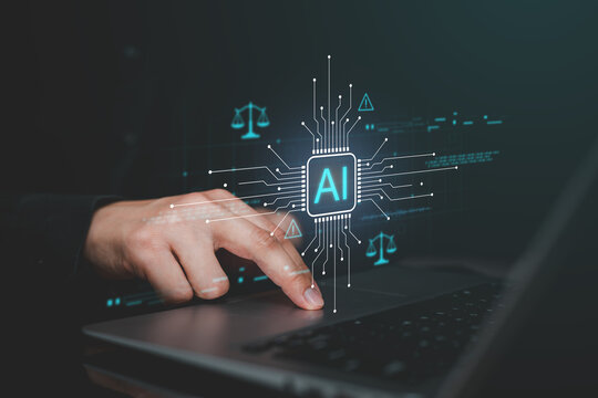 Artificial intelligence and AI ethics concept with human hand using laptop, digital AI processor, justice symbols and data interface representing responsible technology, regulation and governance.