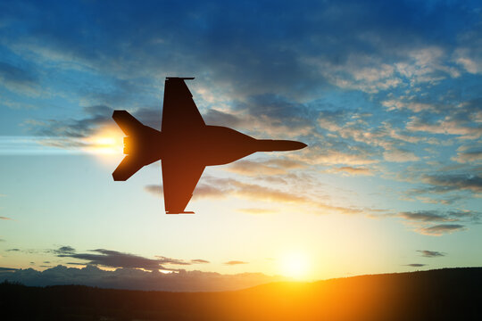 Air Force Day. Aircraft silhouette on background of sunset. Combat flight of interceptor on a mission.