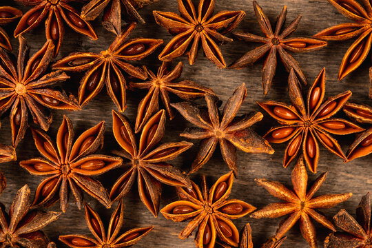 Star anise on old dark wooden background. Shot from above. Top view.