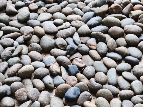 Natural smooth river pebbles and stones texture background for zen garden decoration and spa concept