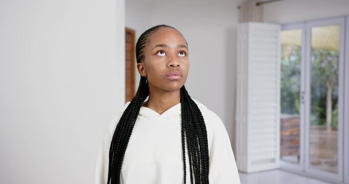 High speed photography for dynamic scenes, wearing white hoodie, young woman looking down with braid