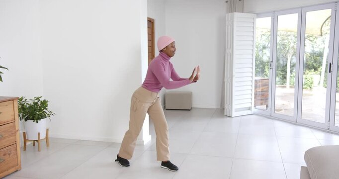 High speed photography for dynamic scenes, exercising indoors, woman stretching and balancing in bri
