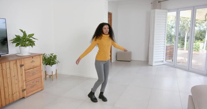 High speed photography for dynamic scenes, dancing in living room, woman enjoying music and having f