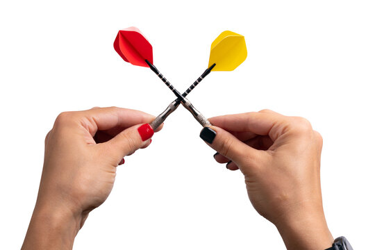 Close-up of two hands holding red and yellow darts crossed on transparent background, symbolizing competition, challenge, and teamwork.