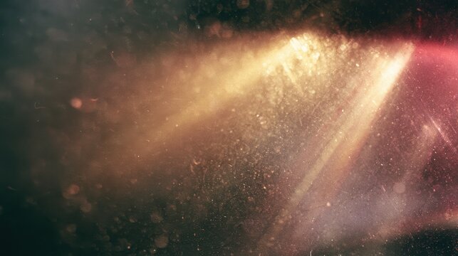 Golden light ray shining diagonally through dark misty space filled with illuminated dust particles and lens flare elements.