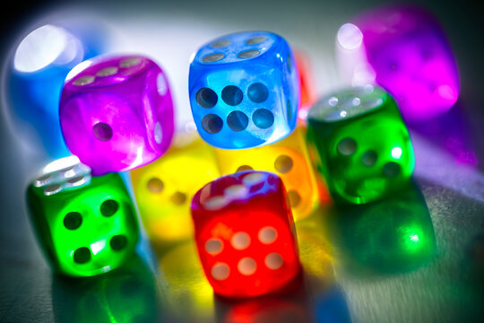 Roll the dice chance, throwing and rolling colored dice on a dark background