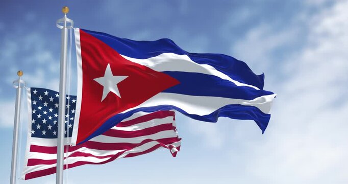 Cuba and US national flags waving on a clear day