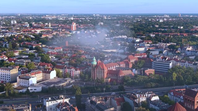 Smoke column rising over Berlin buildings, indicating a significant fire incident and potential infrastructure impact. Fabulous aerial view descending drone panorama