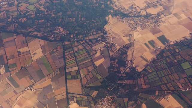 High Aerial View of French Countryside from Above. Symmetrical Patterns of Fields and Browning from Heatwaves in 2026.