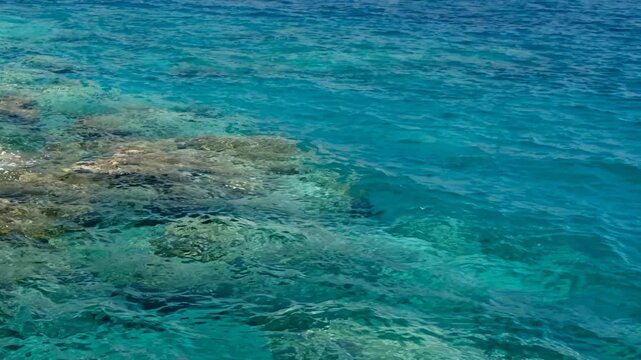 Video of the stones on the bottom with turquoise clear Mediterranean sea water. Crete, Greece