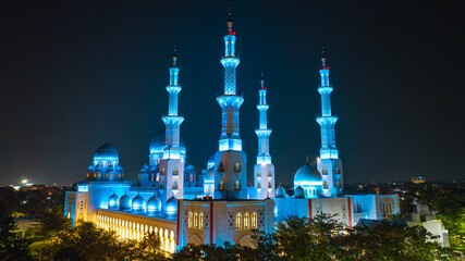 Aerial view of Sheikh Zayed Grand Mosque illuminated in blue light at night in Surakarta, Central Java, Indonesia. © huong