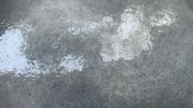Close-up of White Foam Bubbles Floating on Water Surface Video Footage