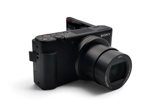 Photo of a black Sony ZV-1 compact digital camera with a ZEISS Vario-Sonnar T* lens and flipped-out articulated LCD screen, ideal for photography and vlogging.