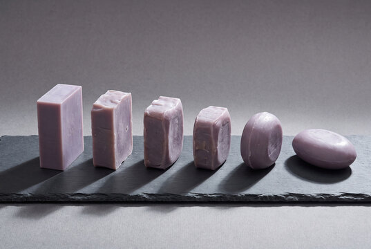 Lavender soap bars arranged on dark slate background