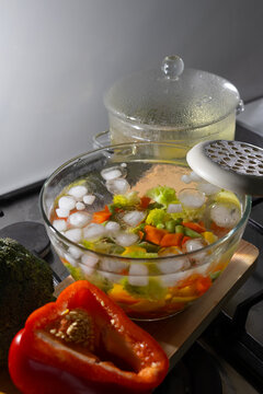 Cooling blanched vegetables in an ice water bath on a kitchen counter