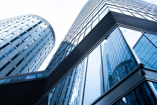 Low angle view of modern glass office towers in Warsaw Poland showing reflective facades geometric forms and contemporary urban architecture