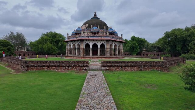 Delhi, India : Tilt up footage from the garden of the tomb of Isa Khan, mausoleum built between 1547 and 1548 located within the Humayun's Tomb complex in Delhi, India under cloudy sky