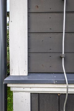 Wooden Facade Detail with Metal Drip Edge and Lightning Conductor