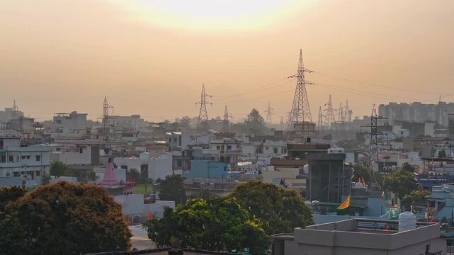 An aerial view of Dehradun, an Indian city during sunrise or sunset, with cloudy weather and rows of residential houses.