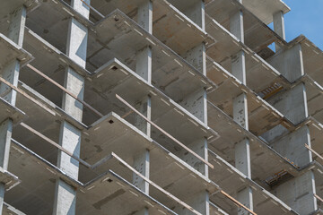Construction progress of a high-rise building against a clear blue sky © beholdereye