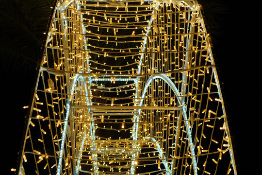 a Christmas light backdrop, a three-dimensional decorative structure, or a tunnel illuminated