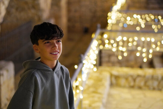 Christmas, travel, vacations, and getaways. Sales, back to school... a preteen boy in a lit-up town