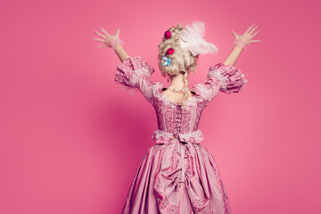 Fototapeta na wymiar Back view photo of lady in medieval noble costume dress raise hands up happy isolated pink color background