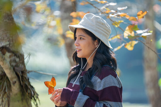 Young woman wears bucket hat and striped sweater