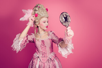 Photo of lady princess looking in mirror adjusting wig for festive event occasion isolated pink color background © deagreez