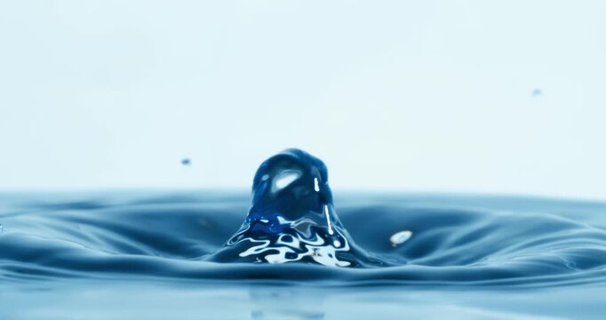 Drop of water falls into a drop of water in a super slow motion. Shot on super slow motion 1600 fps.