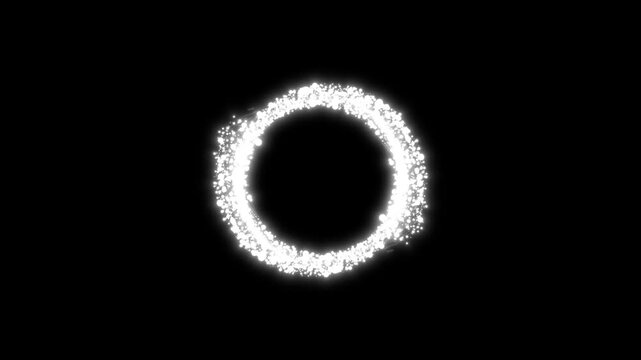 White glowing particle rings forming circular loops and dissolving into sparkling fragments on a black background