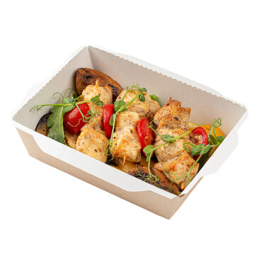 Grilled chicken skewers with vegetables in box