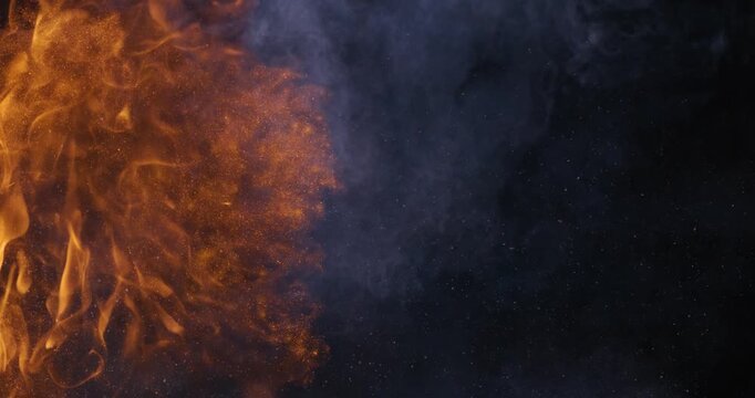 Abstract orange flames with smoke on black background.
