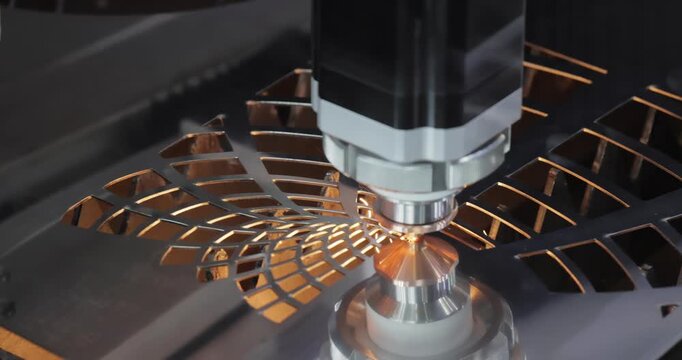 Industrial CNC laser cutting machine with flying sparks in metal fabrication.
