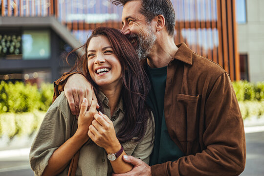 Laughing Couple Embracing on Urban Street Showing Love, Happiness and Affectionate Relationship