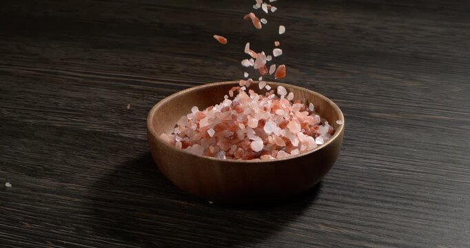 Himalayan pink salt in a super slow motion, natural mineral seasoning for healthy cooking and spa concepts. Super slow motion 1500 fps.