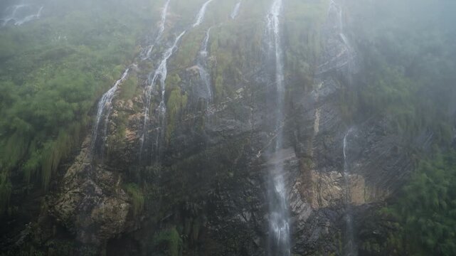 Misty Rocky Rugged Mountains Waterfall in Mist, Atmospheric Moody Waterfalls Falling off Rocks in the Himalayas Mountains in Nepal