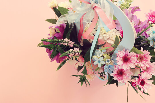 Top view image of romantic and delicate flowers on pastel background