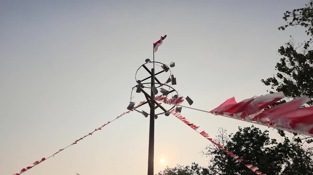 Close-up of a greased pole being prepared for Panjat Pinang, a traditional Indonesian game celebrating Independence Day and local cultural heritage.