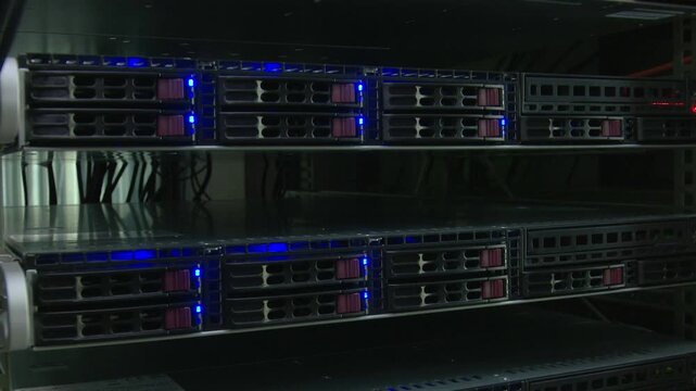 Enterprise server storage array with glowing blue status indicators a close