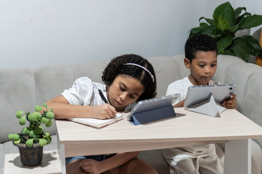 Children studying e-learning with digital tablets and notebook