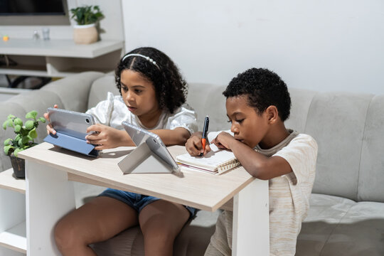 Children learning at home with digital technology and notebook