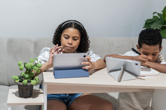 Children learning online and doing homework with tablets