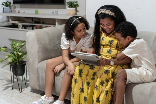 Mother and children bonding using digital tablet at home