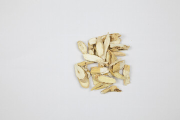 Dried Herbal Root Slices Isolated on White Background © LamQuang