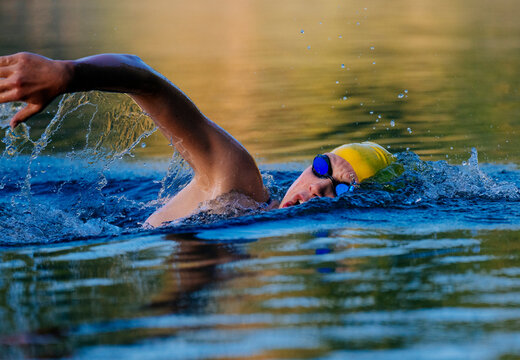 White swimmer performing freestyle stroke in open water