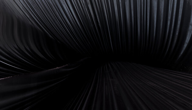Black fabric with deep folds and smooth texture