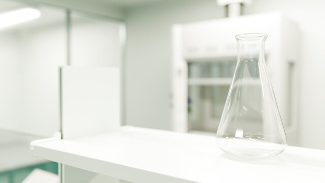 Empty glass flask on white lab shelf in modern chemistry laboratory