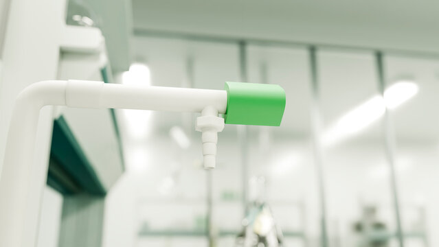 White valve with green handle on pipe in laboratory