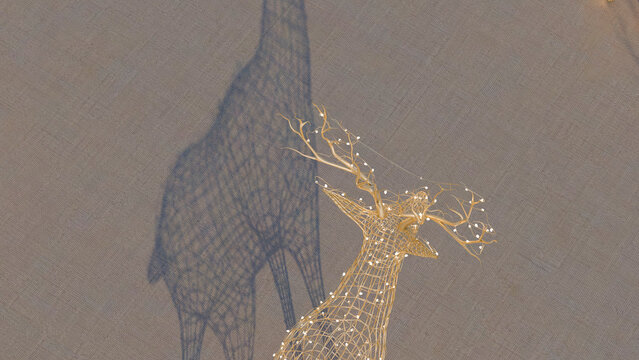 Wireframe deer sculpture with illuminated decorative branches indoors